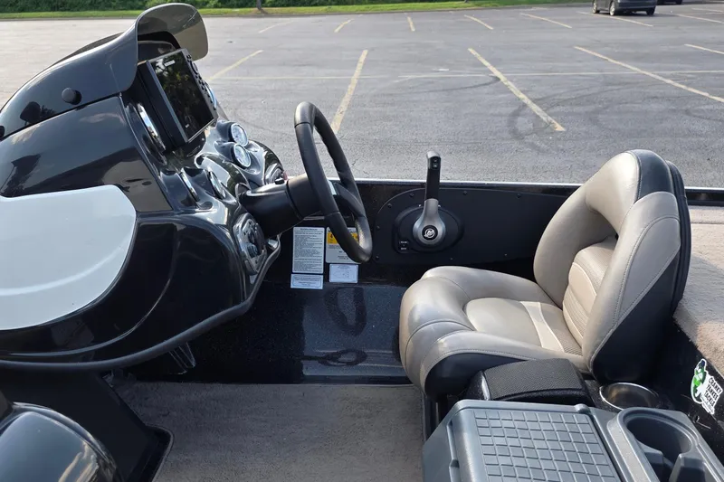 Slide: The Image of Interior of a 2012 Nitro Z-7 boat featuring steering wheel and comfortable seating. - 16