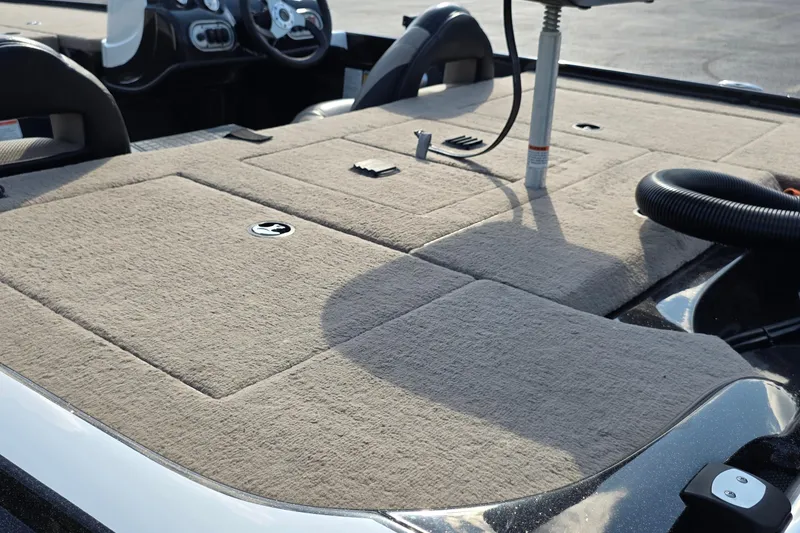 Slide: The Image of 2012 Nitro Z-7 boat interior with beige carpet and steering console. - 22