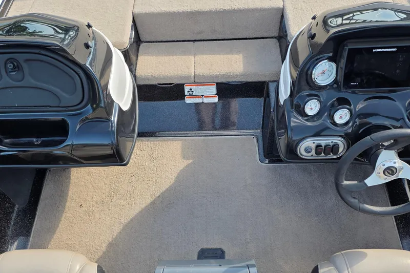 Slide: The Image of Interior view of a 2012 Nitro Z-7 boat dashboard with gauges and steering wheel. - 31