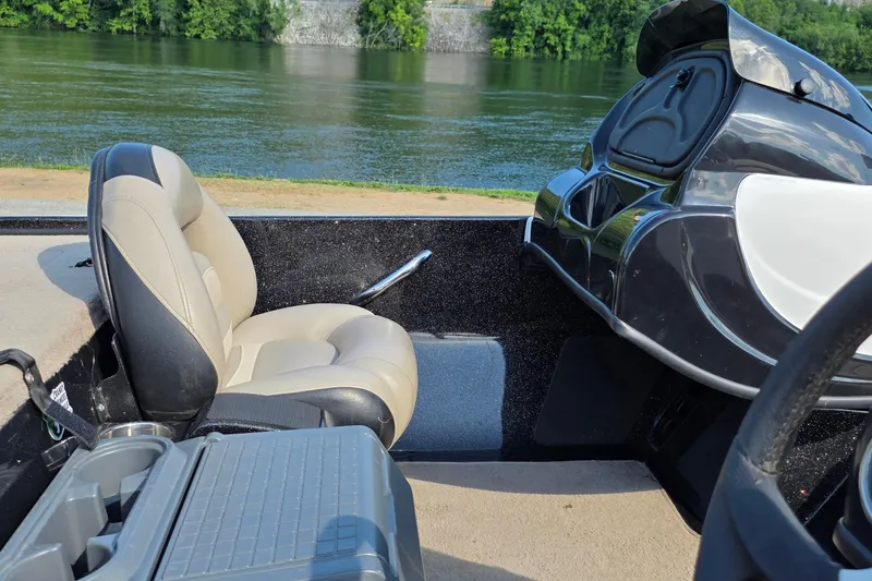 Slide: The Image of Interior of a 2012 Nitro Z-7 boat by a scenic riverbank. - 15