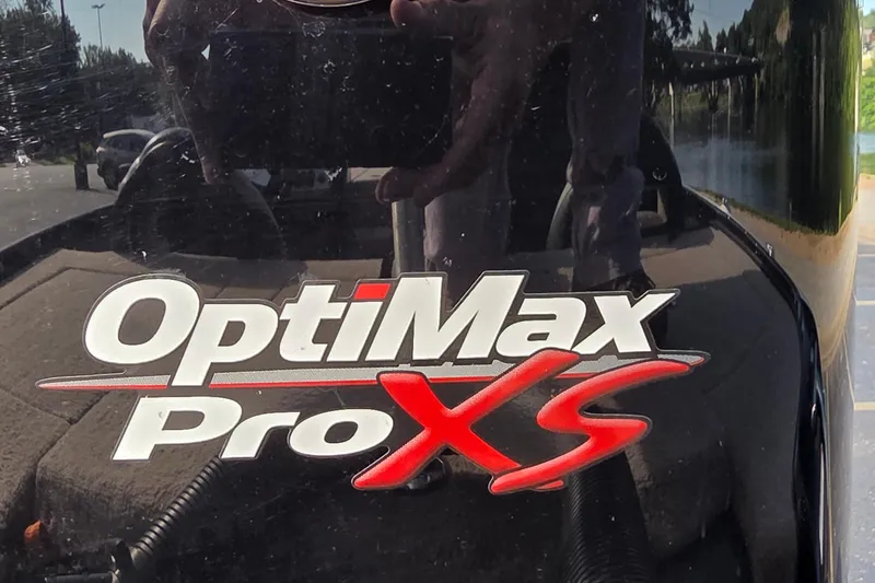 Slide: The Image of OptiMax Pro XS logo on a 2012 Nitro Z-7 boat engine. - 18
