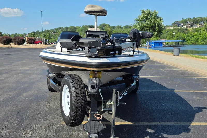 Slide: The Image of 2012 Nitro Z-7 boat on trailer in parking lot near lake. - 8