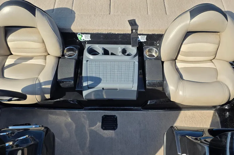 Slide: The Image of Two beige seats in a 2012 Nitro Z-7 boat interior with cup holders. - 35