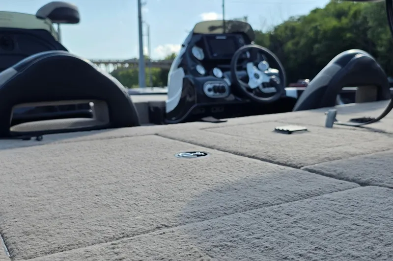 Slide: The Image of Interior view of a 2012 Nitro Z-7 boat, featuring a carpeted deck and steering console. - 21