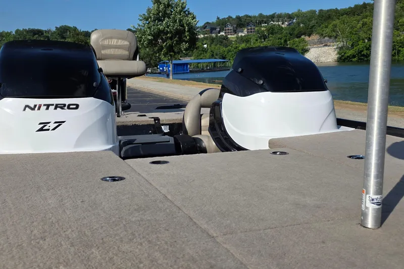 Slide: The Image of 2012 Nitro Z-7 boat with dual engines, docked by a scenic lakeside. - 14