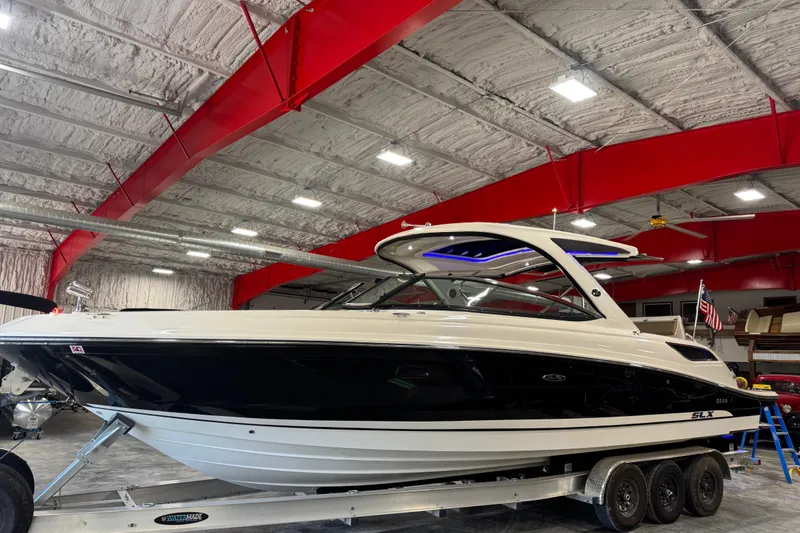 The Image of 2016 Sea Ray SLX 350 boat in a warehouse with red beams and bright lighting. - 1