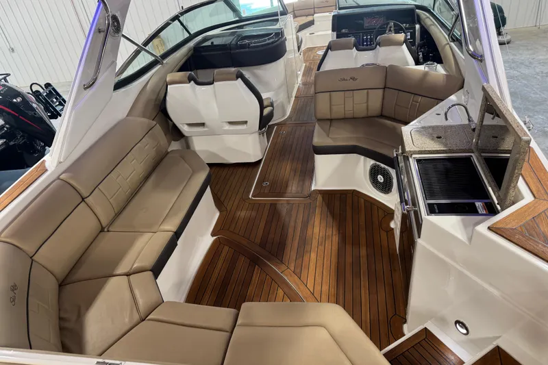 Slide: The Image of Luxurious interior of 2016 Sea Ray SLX 350 boat with plush seating and wooden flooring. - 12