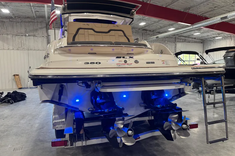 Slide: The Image of 2016 Sea Ray SLX 350 boat in a garage, showcasing dual propellers and blue lighting. - 5
