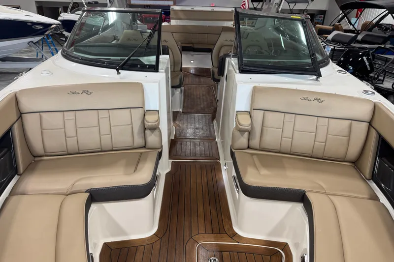Slide: The Image of 2016 Sea Ray SLX 350 boat interior with tan leather seating and wooden flooring. - 6
