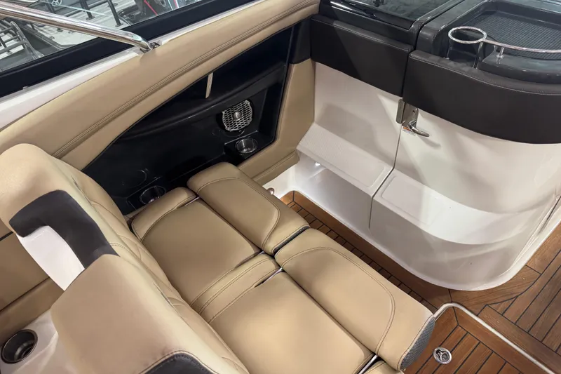 Slide: The Image of 2016 Sea Ray SLX 350 interior with tan leather seating and wood flooring. - 7