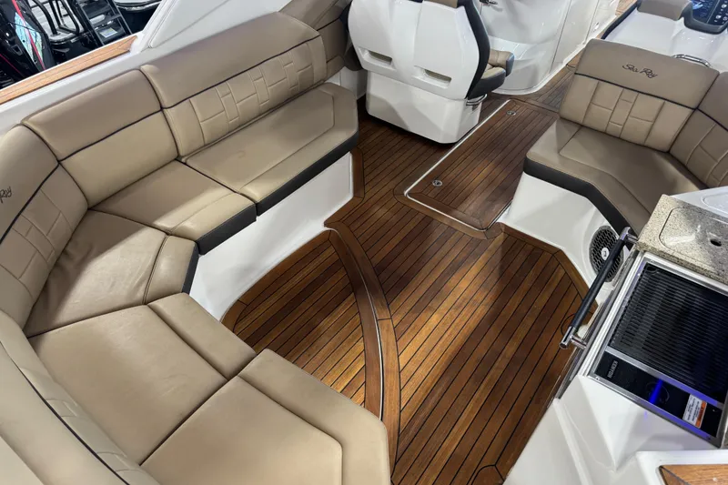Slide: The Image of Luxurious interior of 2016 Sea Ray SLX 350 with tan seating and wooden flooring. - 9