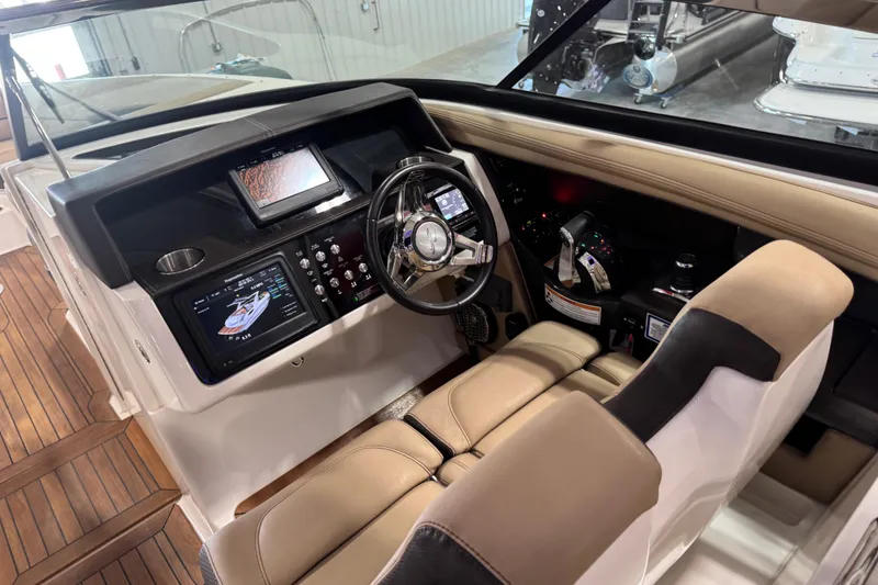 Slide: The Image of Cockpit of 2016 Sea Ray SLX 350 boat with modern controls and navigation displays. - 8