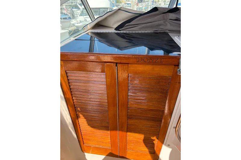 Slide: The Image of 1991 Donzi 255 LXC boat interior with polished wooden cabinet. - 9