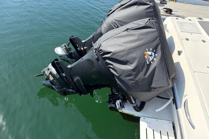 Slide: The Image of Twin outboard motors on a 1991 Donzi 255 LXC boat, covered and docked. - 10
