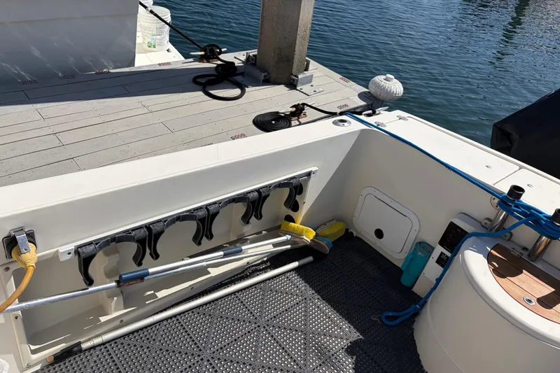 Slide: The Image of 1991 Donzi 255 LXC boat deck with fishing rod holders and dock view. - 7
