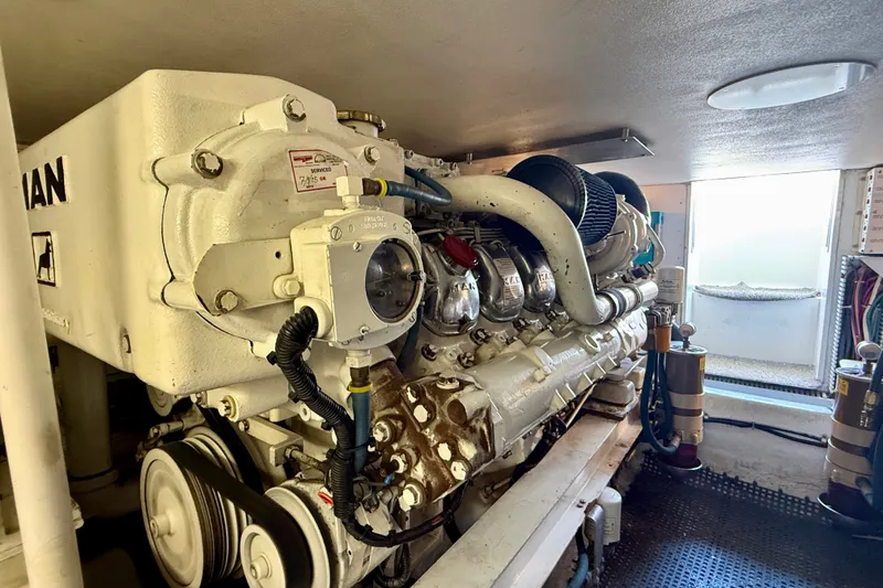 Slide: The Image of Engine room of a 1994 Viking 47 Convertible yacht, showcasing a powerful marine engine. - 76