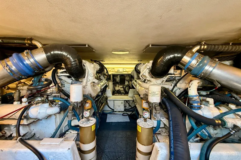 Slide: The Image of Engine room of a 1994 Viking 47 Convertible yacht, showcasing dual engines and mechanical components. - 73