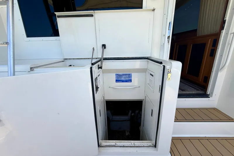 Slide: The Image of Engine room access on a 1994 Viking 47 Convertible yacht, featuring open hatch and steps. - 42