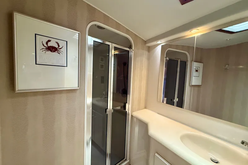 Slide: The Image of Bathroom interior of 1994 Viking 47 Convertible yacht with framed crab artwork. - 27