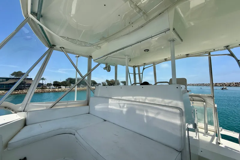 Slide: The Image of 1994 Viking 47 Convertible yacht interior with white seating and ocean view. - 59