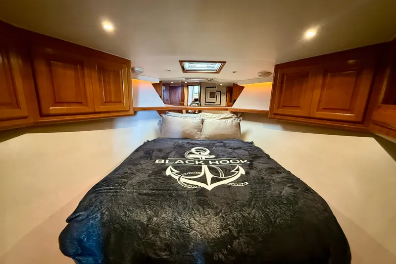 Slide: The Image of Cozy cabin interior of 1994 Viking 47 Convertible yacht with anchor-themed bedding. - 25