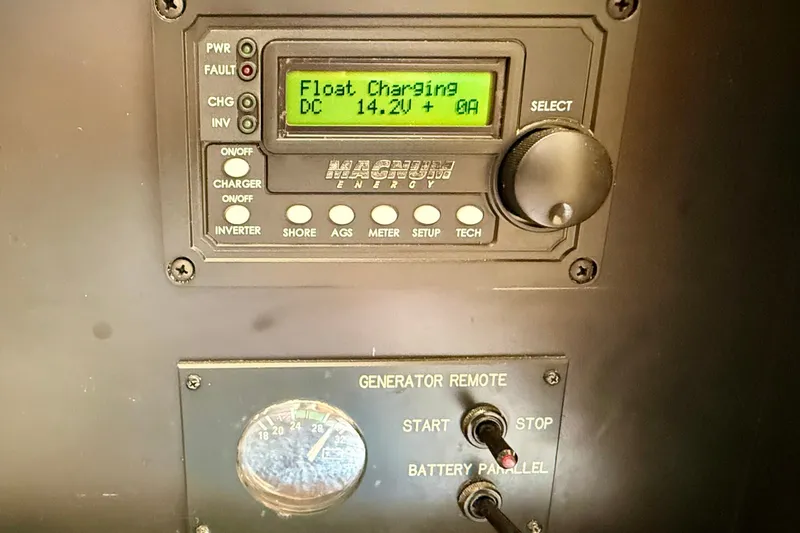 Slide: The Image of Control panel of a 1994 Viking 47 Convertible, displaying float charging at 14.2V. - 38