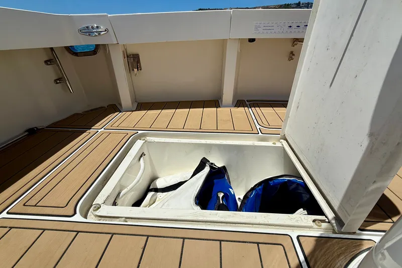 Slide: The Image of Storage compartment on 1994 Viking 47 Convertible boat deck, open with bags inside. - 47