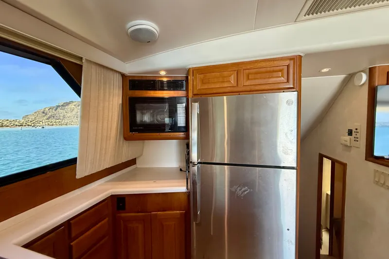 Slide: The Image of Interior of 1994 Viking 47 Convertible yacht kitchen with stainless steel appliances and ocean view. - 20