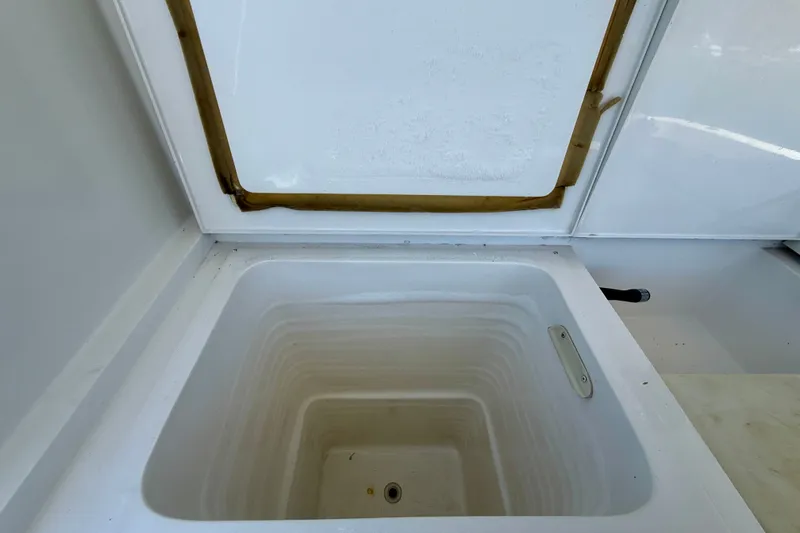 Slide: The Image of Open storage compartment on a 1994 Viking 47 Convertible boat. - 52