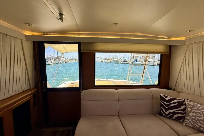 Slide: The Image of Interior view of 1994 Viking 47 Convertible yacht with marina backdrop. - 16
