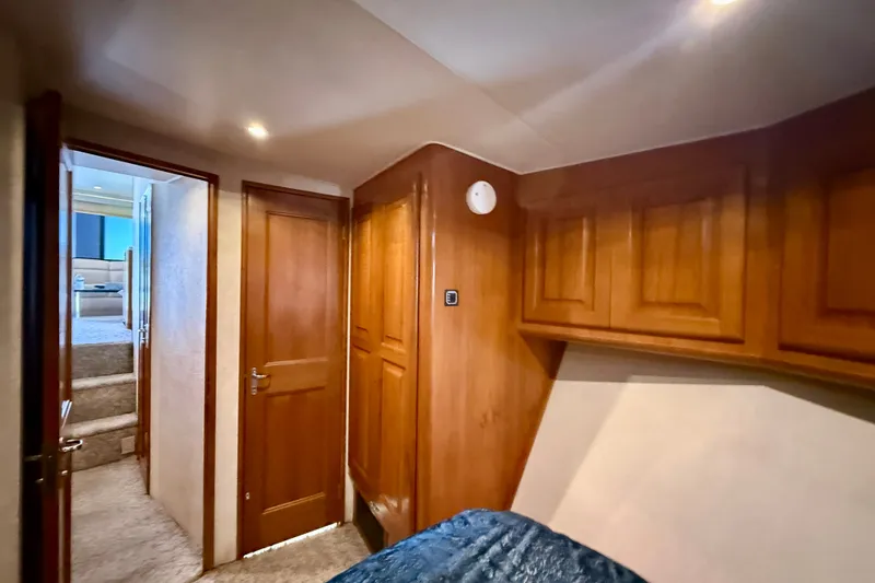 Slide: The Image of Interior of 1994 Viking 47 Convertible yacht with wooden cabinetry and cozy hallway. - 30