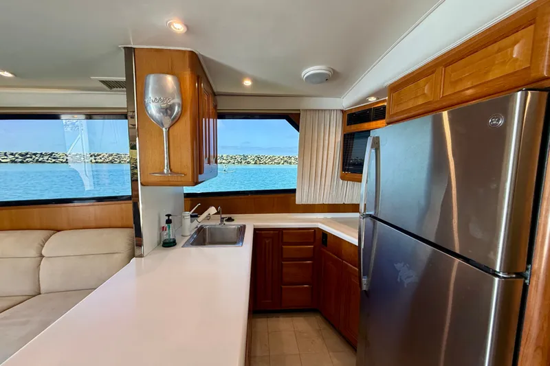 Slide: The Image of Interior of 1994 Viking 47 Convertible yacht with modern kitchen and ocean view. - 18