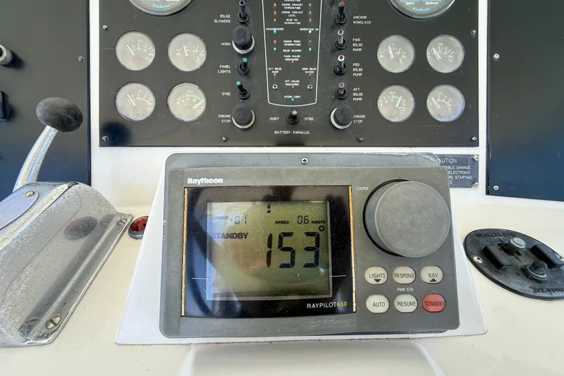 Slide: The Image of Control panel of a 1994 Viking 47 Convertible boat with Raytheon autopilot display. - 65