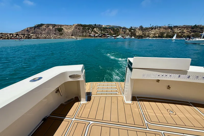 Slide: The Image of View from a 1994 Viking 47 Convertible yacht, overlooking a scenic coastal area. - 44