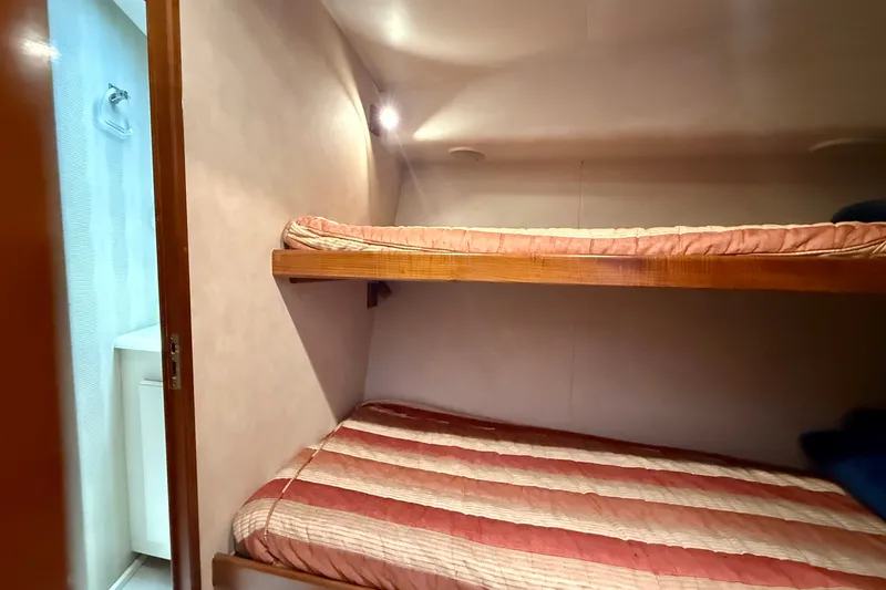 Slide: The Image of Bunk beds in 1994 Viking 47 Convertible yacht cabin, with adjacent bathroom. - 24