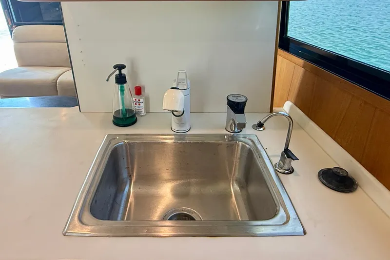 Slide: The Image of Kitchen sink area on a 1994 Viking 47 Convertible yacht with ocean view. - 22