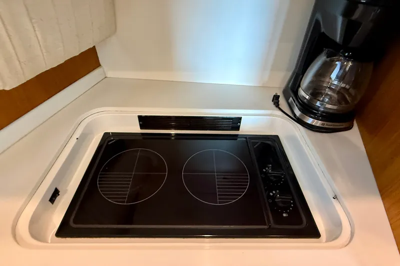 Slide: The Image of Built-in stovetop and coffee maker in 1994 Viking 47 Convertible yacht kitchen. - 36
