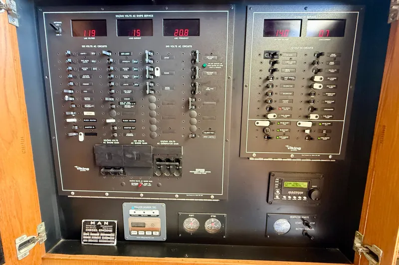 Slide: The Image of Electrical panel of a 1994 Viking 47 Convertible boat, featuring various circuit breakers and controls. - 37