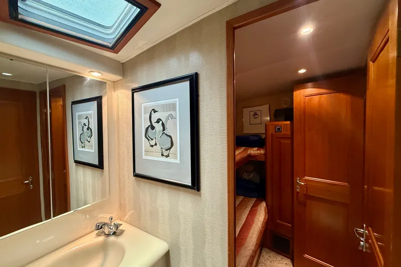 Slide: The Image of Interior of 1994 Viking 47 Convertible yacht with framed artwork and wooden cabinetry. - 31