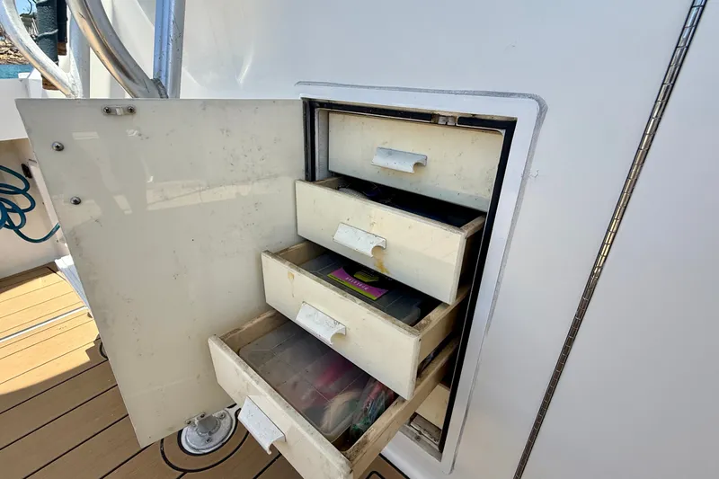 Slide: The Image of Open storage drawers on a 1994 Viking 47 Convertible boat, showcasing interior compartments. - 50