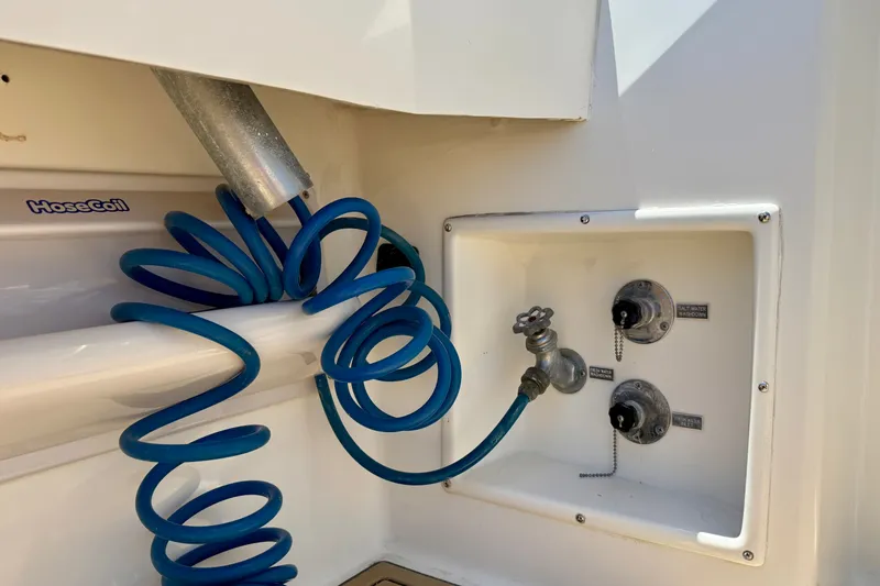 Slide: The Image of Blue coiled hose and water connections on a 1994 Viking 47 Convertible yacht. - 51