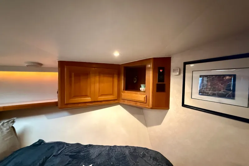 Slide: The Image of Cozy interior of 1994 Viking 47 Convertible with wooden cabinets and framed artwork. - 33
