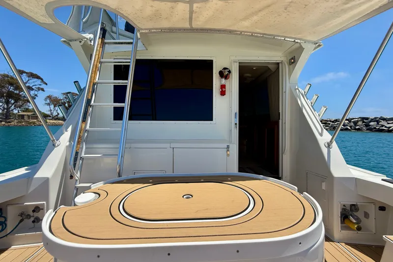 Slide: The Image of 1994 Viking 47 Convertible yacht deck with ladder, table, and ocean view. - 41