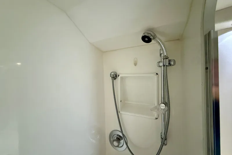 Slide: The Image of Shower area in a 1994 Viking 47 Convertible yacht, featuring a handheld showerhead. - 34
