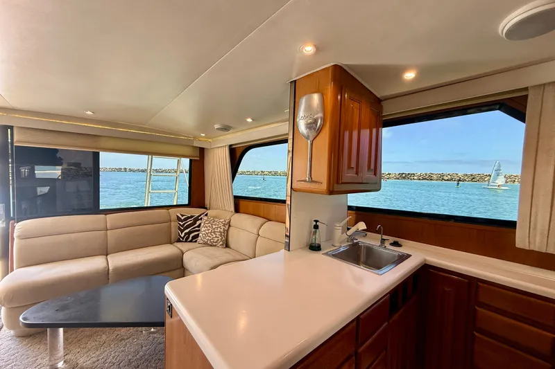 Slide: The Image of Interior of 1994 Viking 47 Convertible yacht with ocean view, featuring a cozy seating area. - 19