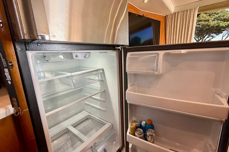 Slide: The Image of Open refrigerator inside a 1994 Viking 47 Convertible yacht, stocked with drinks. - 39