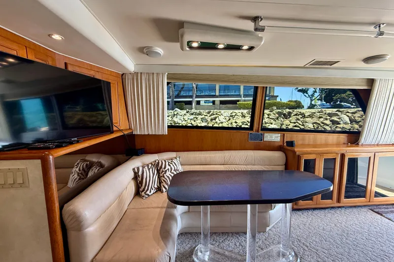 Slide: The Image of Luxurious interior of a 1994 Viking 47 Convertible yacht with plush seating and large windows. - 12
