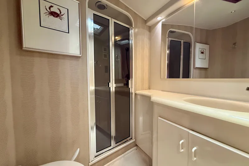Slide: The Image of Bathroom interior of 1994 Viking 47 Convertible yacht with shower and crab artwork. - 28