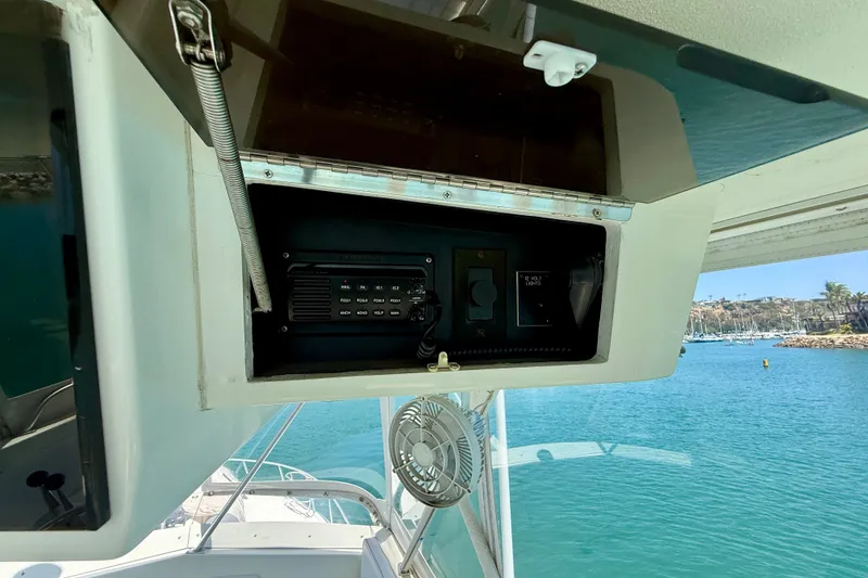 Slide: The Image of Control panel on a 1994 Viking 47 Convertible yacht, overlooking a marina. - 62
