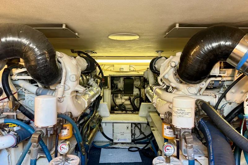 Slide: The Image of Engine room of a 1994 Viking 47 Convertible yacht, showcasing dual engines and mechanical components. - 70